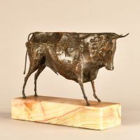 Alt text: Bronze modernist sculpture of a bull atop a marble base