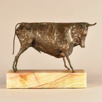 Alt text: Bronze modernist sculpture of a bull atop a marble base