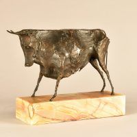 Alt text: Bronze modernist sculpture of a bull atop a marble base