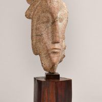 Carved head on reclaimed marble 