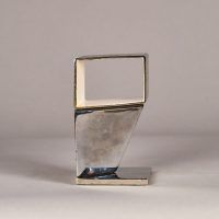 Alt text: Abstract sculpture made of steel and enamel with two geometric shapes fused together