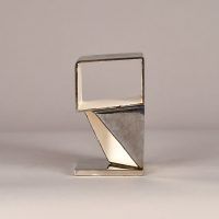 Alt text: Abstract sculpture made of steel and enamel with two geometric shapes fused together