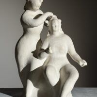 Alt text: Stylized, white sculpture of two women, one standing and one seated
