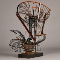 Alt text: Abstract metal sculpture made of a deconstructed oscillating fan