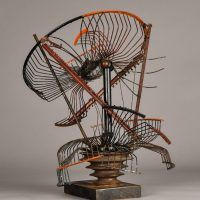 Alt text: Abstract metal sculpture made of a deconstructed oscillating fan