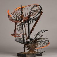 Alt text: Abstract metal sculpture made of a deconstructed oscillating fan