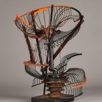 Alt text: Abstract metal sculpture made of a deconstructed oscillating fan