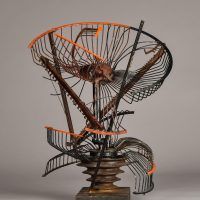 Alt text: Abstract metal sculpture made of a deconstructed oscillating fan