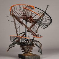 Alt text: Abstract metal sculpture made of a deconstructed oscillating fan