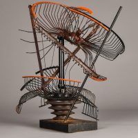 Alt text: Abstract metal sculpture made of a deconstructed oscillating fan