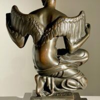 Alt text: Bronze sculpture of Philomela from Greek mythology, kneeling with wings growing from her back