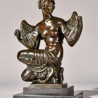 Alt text: Bronze sculpture of Philomela from Greek mythology, kneeling with wings growing from her back