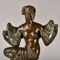 Alt text: Bronze sculpture of Philomela from Greek mythology, kneeling with wings growing from her back