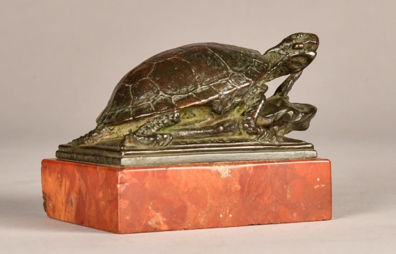 Alt text: Small bronze sculpture of a turtle eating a frog