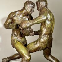 Alt text: Bronze sculpture of two boxers engaged in a fight