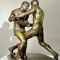 Alt text: Bronze sculpture of two boxers engaged in a fight
