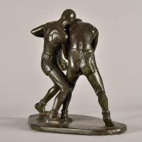 Alt text: Bronze sculpture of two boxers fighting