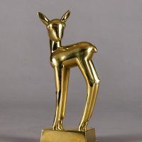 Alt text: Polished bronze sculpture of a long-legged fawn