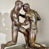 Alt text: Bronze sculpture of two boxers engaged in a fight
