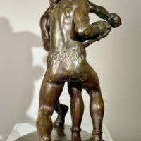 Alt text: Bronze sculpture of two boxers engaged in a fight