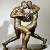 Alt text: Bronze sculpture of two boxers engaged in a fight