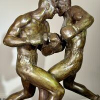 Alt text: Bronze sculpture of two boxers engaged in a fight