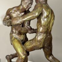 Alt text: Bronze sculpture of two boxers engaged in a fight