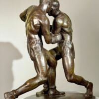 Alt text: Bronze sculpture of two boxers engaged in a fight