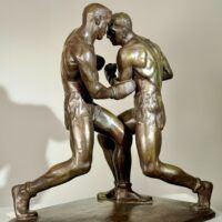 Alt text: Bronze sculpture of two boxers engaged in a fight