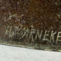 Alt text: Bronze sculpture, signature detail that reads H. Warneke