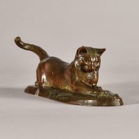 Alt text: Bronze sculpture of a cat stretching