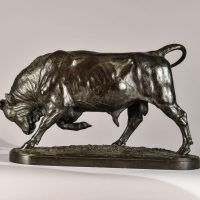 Alt text: Bronze sculpture of a bull with his head down and front right leg lifted, side view