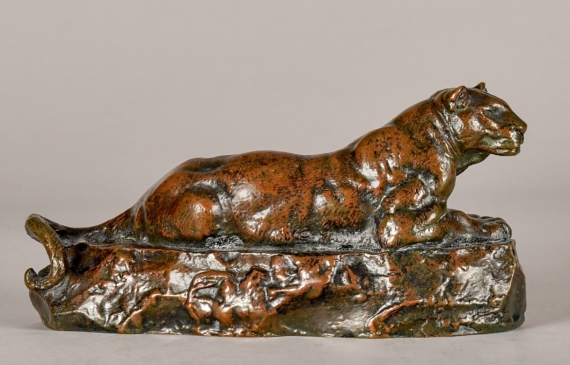 Alt text: Bronze sculpture of a lounging Tunisian panther