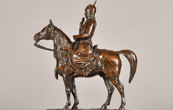 Alt text: Bronze sculpture of a warrior on horseback atop a marble base
