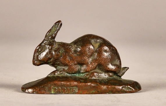 Alt text: Small bronze sculpture of rabbit with ears up