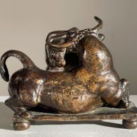 Alt text: Bronze sculpture of a woman with a bull