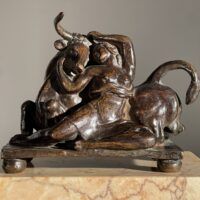 Alt text: Bronze sculpture of a woman with a bull