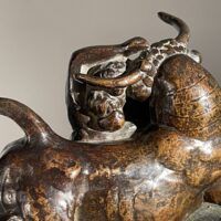 Alt text: Bronze sculpture of a woman with a bull