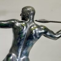 Alt text: Bronze sculpture of man with a spear