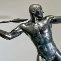 Alt text: Bronze sculpture of man with a spear