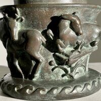 Alt text: Bronze sculpture of a bear on a pedestal