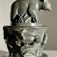 Alt text: Bronze sculpture of a bear on a pedestal