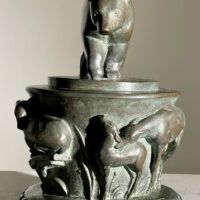 Alt text: Bronze sculpture of a bear on a pedestal