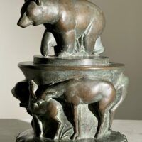 Alt text: Bronze sculpture of a bear on a pedestal