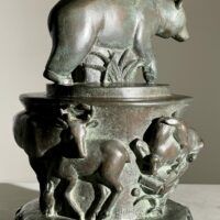 Alt text: Bronze sculpture of a bear on a pedestal