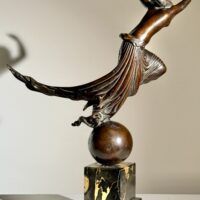 Alt text: Bronze sculpture of a semi-nude female figure