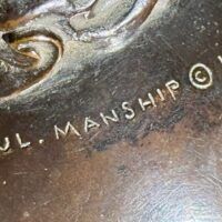 Alt text: Bronze sculpture, signature detail
