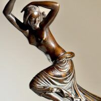 Alt text: Bronze sculpture of a semi-nude female figure