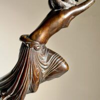 Alt text: Bronze sculpture of a semi-nude female figure