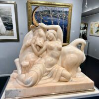 Alt text: Marble sculpture of a woman and a bull with bronze horns